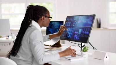 A Woman looking at a laptop